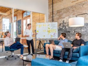 Employees Reviewing Business Plan on Whiteboard