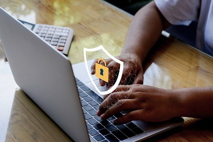 Hands Typing on Laptop With Lock Icon 1